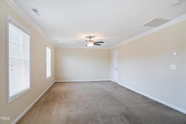 empty room with carpet floors, visible vents, and crown molding