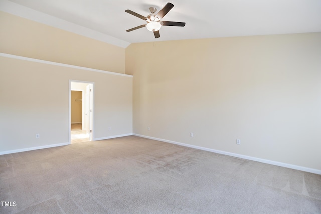 empty room with a ceiling fan, lofted ceiling, light carpet, and baseboards