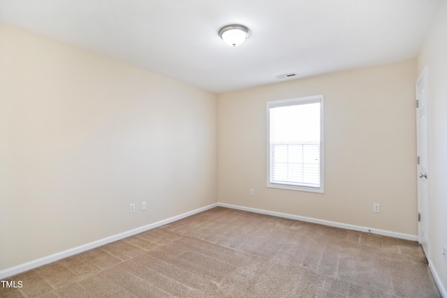 unfurnished room with light carpet, baseboards, and visible vents