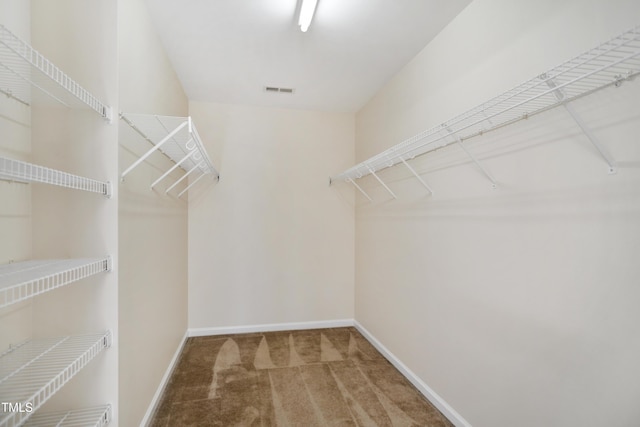 walk in closet with carpet floors and visible vents