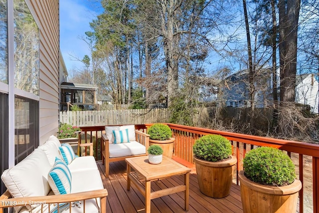 deck with an outdoor hangout area and fence