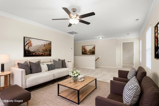 living room featuring ornamental molding, ceiling fan, and baseboards