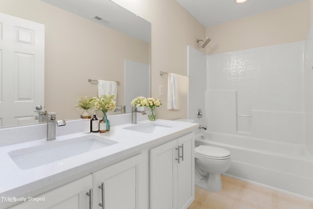 full bath featuring toilet, bathtub / shower combination, and double vanity