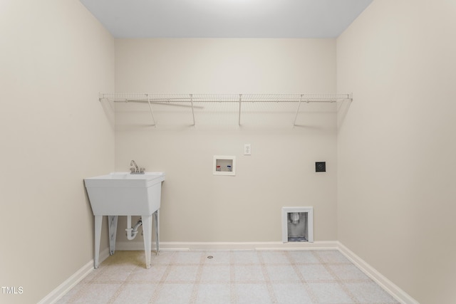 clothes washing area with hookup for a washing machine, hookup for an electric dryer, and baseboards