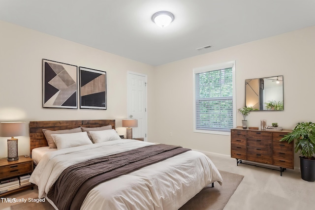 bedroom featuring light carpet