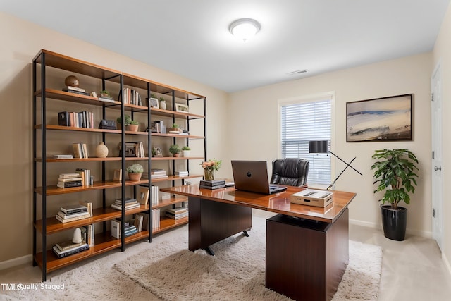 carpeted office featuring baseboards