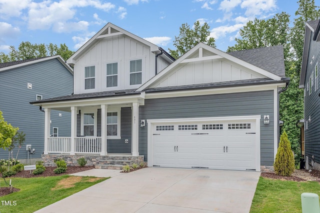 view of front of home with a shingled roof, covered porch, concrete driveway, board and batten siding, and a garage