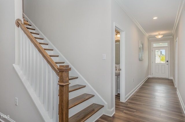 foyer entrance featuring crown molding, recessed lighting, dark wood-type flooring, baseboards, and stairs