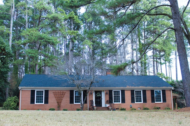 ranch-style home featuring crawl space, brick siding, a front lawn, and roof with shingles