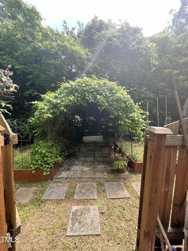 view of yard featuring fence and a patio