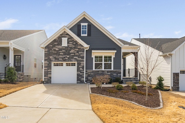 craftsman-style house with a garage, concrete driveway, and stone siding