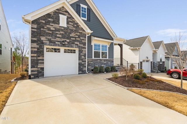 view of front of house featuring a garage, concrete driveway, and stone siding