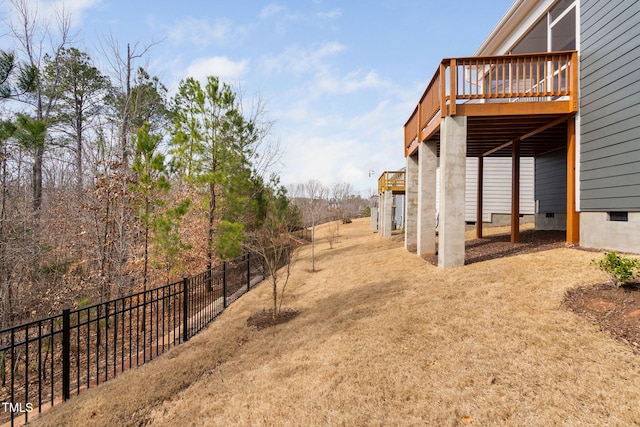 view of yard featuring fence and a deck