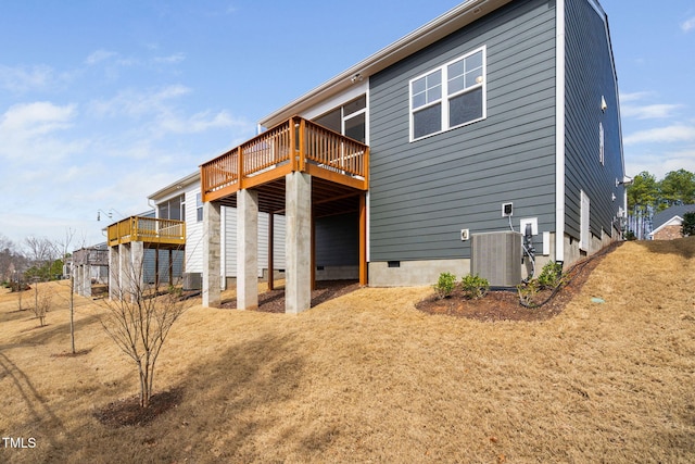 back of house featuring cooling unit, crawl space, and a deck