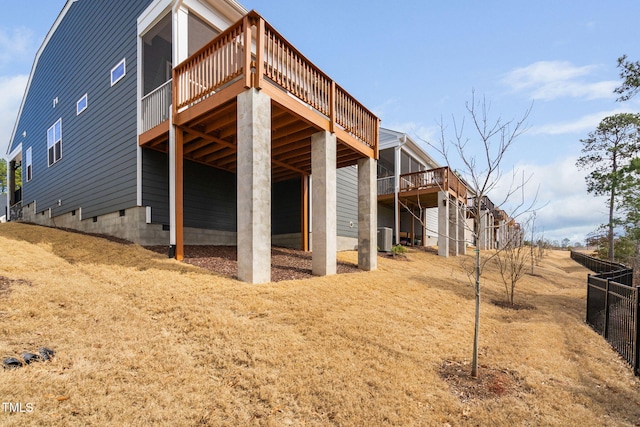 exterior space with central AC and a wooden deck