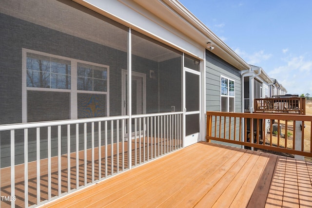 wooden terrace featuring a sunroom