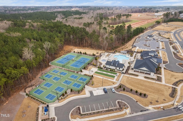 drone / aerial view with a wooded view