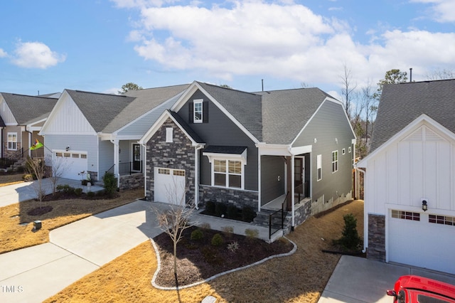 view of front facade with a garage, driveway, a shingled roof, and stone siding