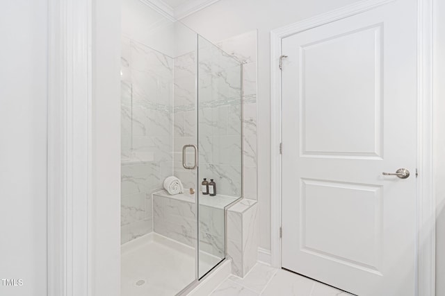 bathroom featuring marble finish floor, a marble finish shower, and crown molding