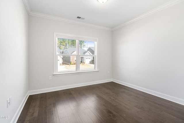 unfurnished room with dark wood-style floors, visible vents, ornamental molding, and baseboards