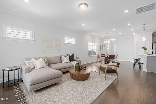 living area with baseboards, crown molding, visible vents, and dark wood-type flooring