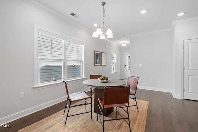 dining room with dark wood-type flooring, visible vents, and baseboards