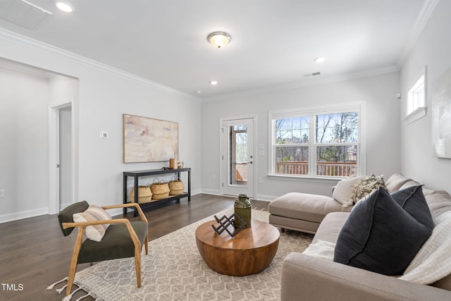 living area featuring wood finished floors, visible vents, and crown molding