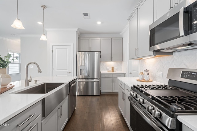 kitchen with visible vents, light countertops, appliances with stainless steel finishes, gray cabinets, and decorative backsplash