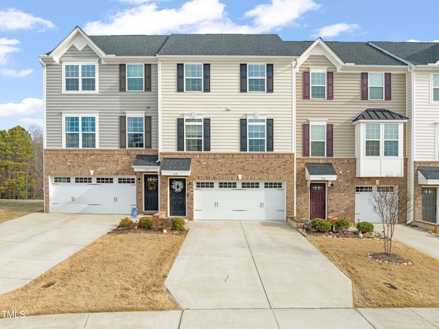 view of front of house featuring brick siding, an attached garage, and driveway