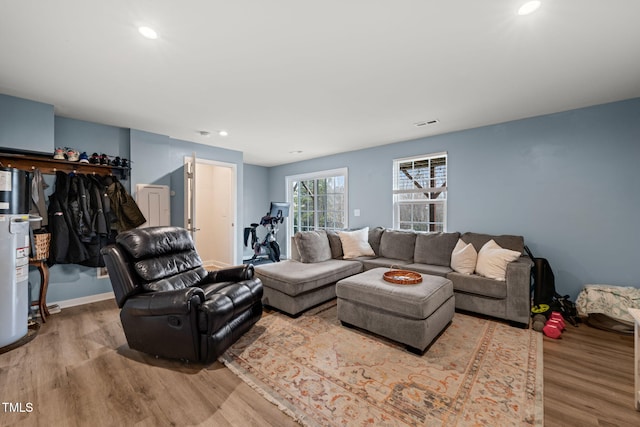 living room with recessed lighting, wood finished floors, and visible vents