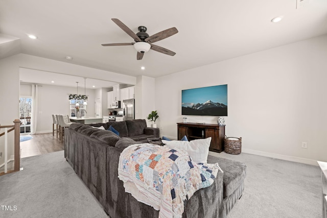 living area with light colored carpet, recessed lighting, baseboards, and ceiling fan