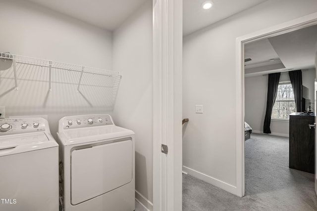 laundry area featuring baseboards, independent washer and dryer, carpet flooring, and laundry area