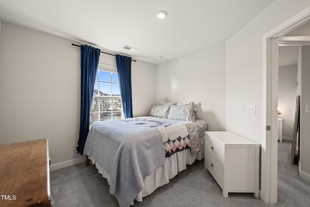 bedroom featuring baseboards, light carpet, and visible vents