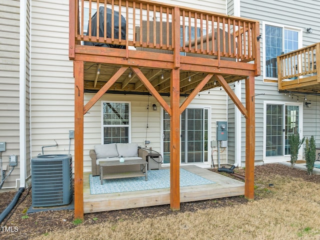 wooden deck featuring an outdoor living space and cooling unit