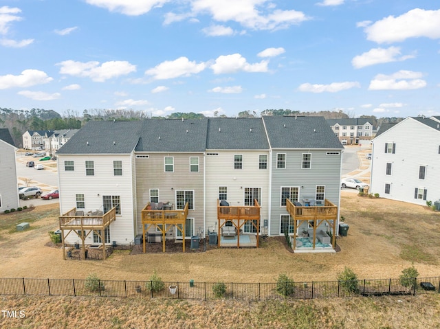 back of house featuring a yard, a fenced backyard, and a deck