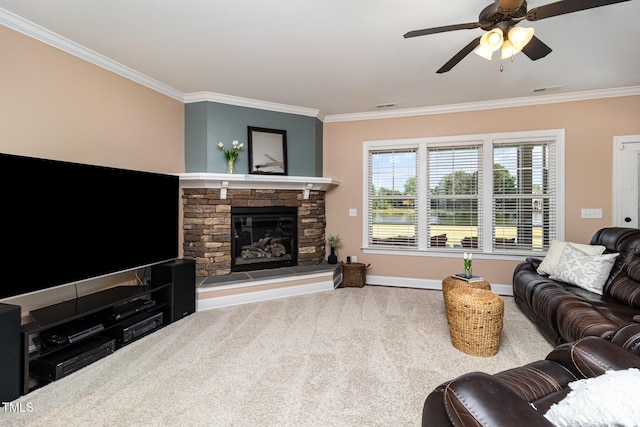 carpeted living area featuring ornamental molding, visible vents, a stone fireplace, and a ceiling fan