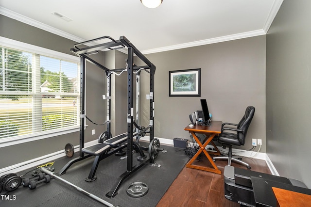 workout room with crown molding, baseboards, and wood finished floors