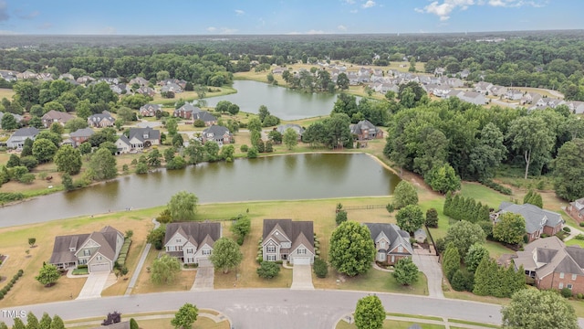 drone / aerial view with a water view and a residential view