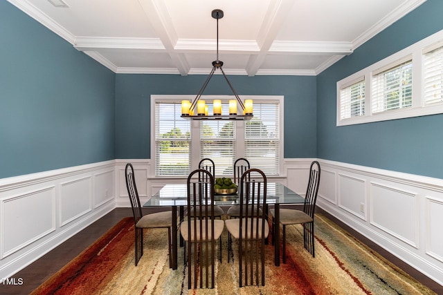 dining area with an inviting chandelier, dark wood-type flooring, beam ceiling, and a wainscoted wall