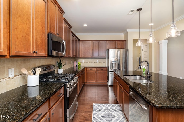 kitchen with dark wood finished floors, crown molding, visible vents, appliances with stainless steel finishes, and a sink