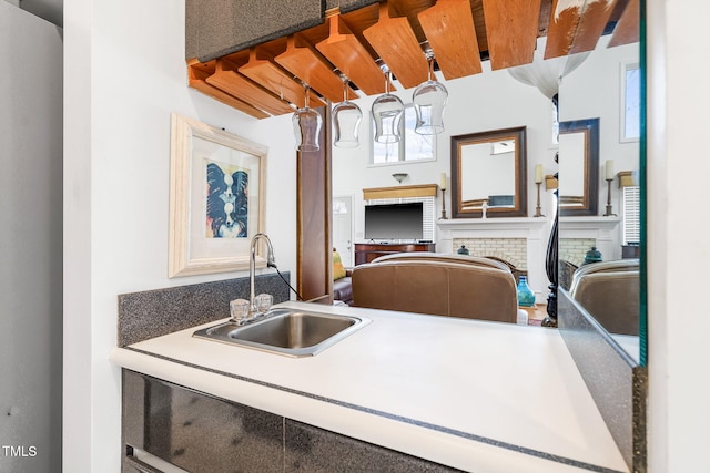 kitchen with a brick fireplace and a sink