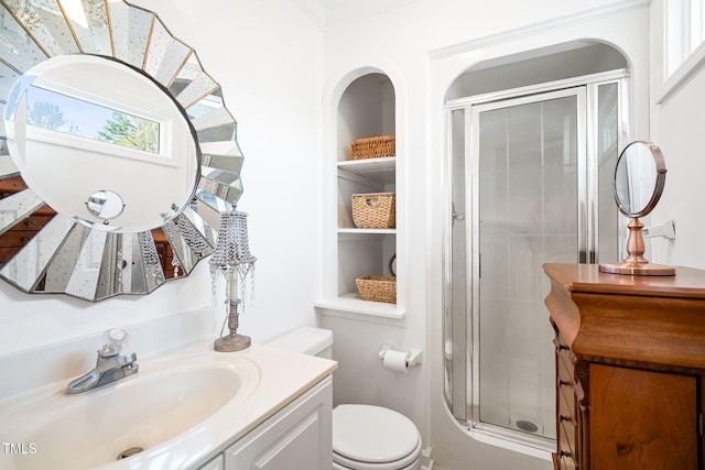 full bath featuring toilet, a shower stall, vanity, and built in features