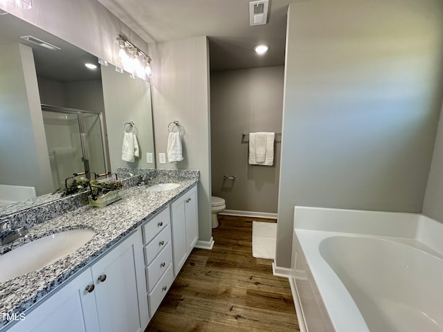 full bathroom featuring visible vents, a garden tub, a stall shower, wood finished floors, and a sink