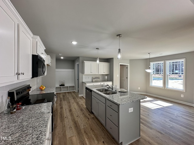 kitchen featuring white cabinetry, wood finished floors, electric stove, and a sink