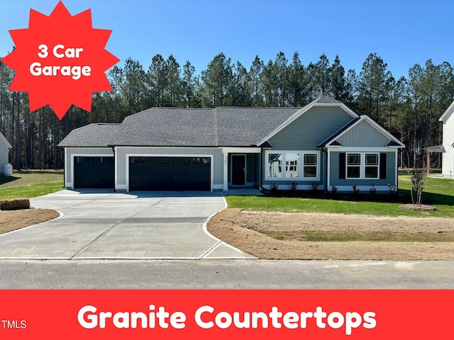 view of front of property with a garage, roof with shingles, concrete driveway, and a front yard