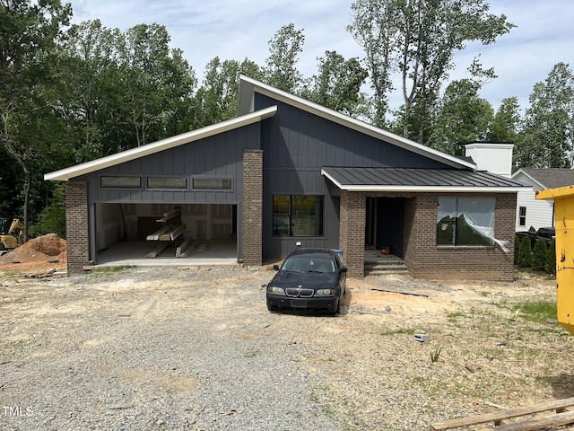 269 Deer Tail Ln Lot 44, Fuquay Varina, NC 27526 - mid-century home with brick siding, a standing seam roof, and metal roof