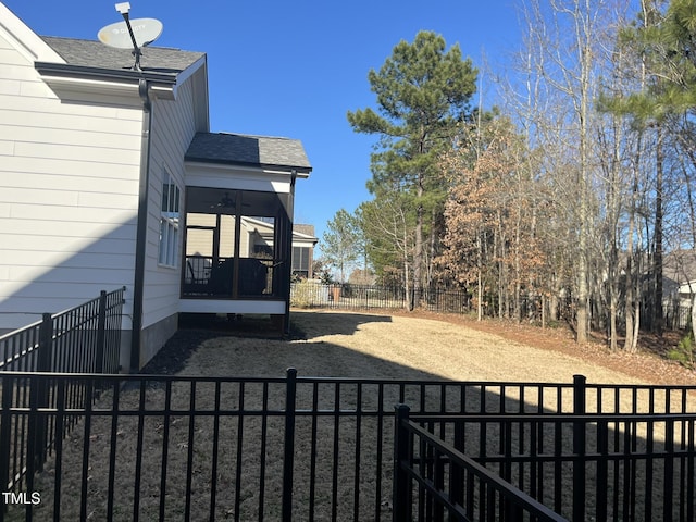 view of yard with a sunroom and a fenced backyard