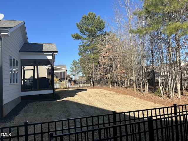 view of yard with a fenced backyard and a sunroom