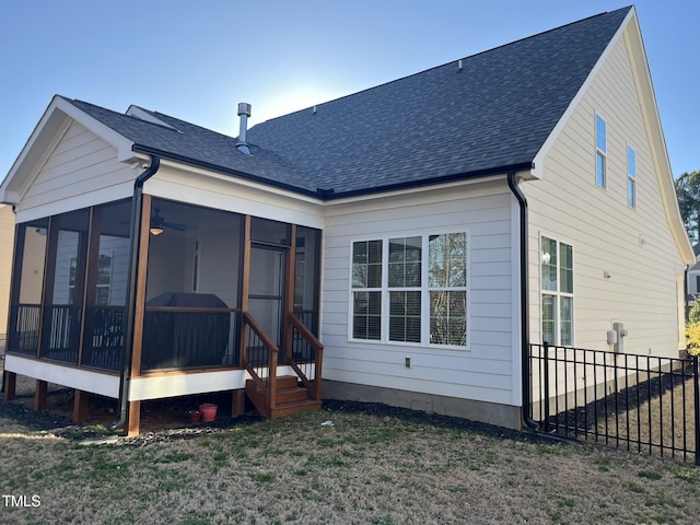 rear view of property with a sunroom, a yard, fence, and roof with shingles