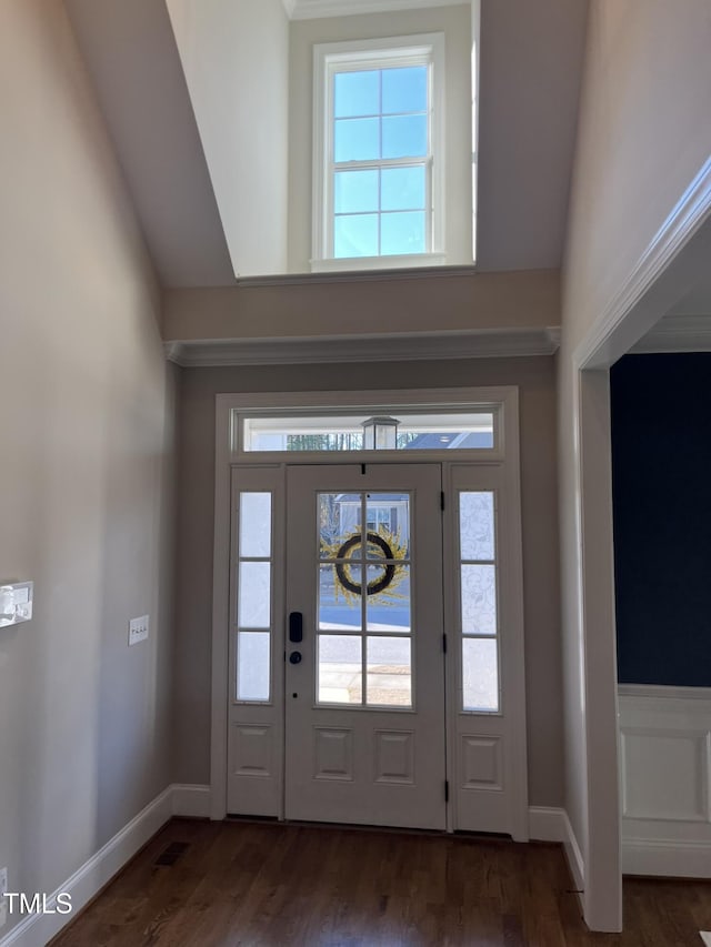 foyer entrance featuring lofted ceiling, baseboards, and wood finished floors